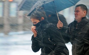 People walk through wind and snow at New York's Times Square